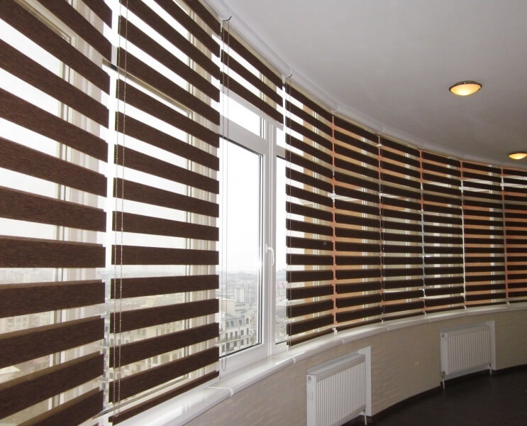 A huge bay window with multi-functional roller blinds